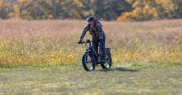 Electric hunting bike speeding through rough terrain with reliable braking.