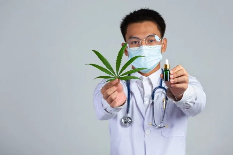 Medical Doctor Holding Cannabis Leaf Bottle Cannabis Oil White Wall 1150 26700